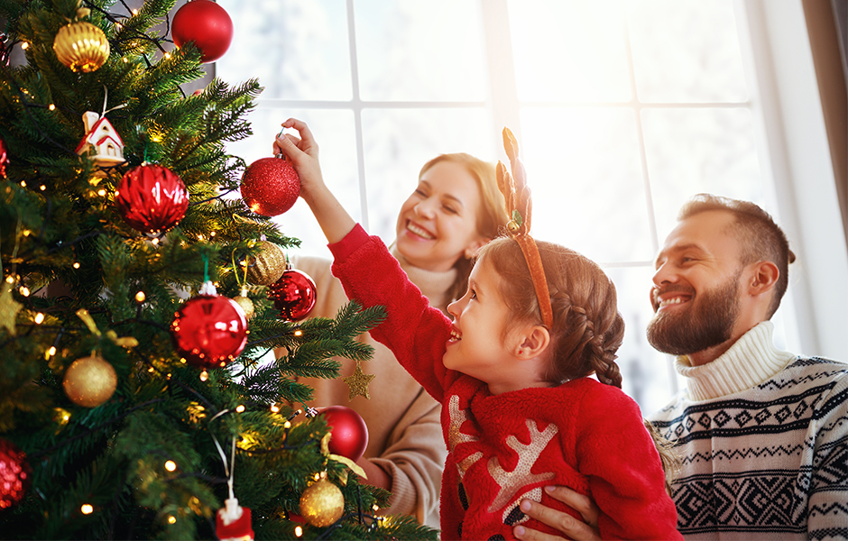 Family decorating Christmas tree